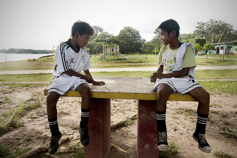 Two boys having a break from playing soccer, small town called Puerto Narino on the side of the Amazon Colombia